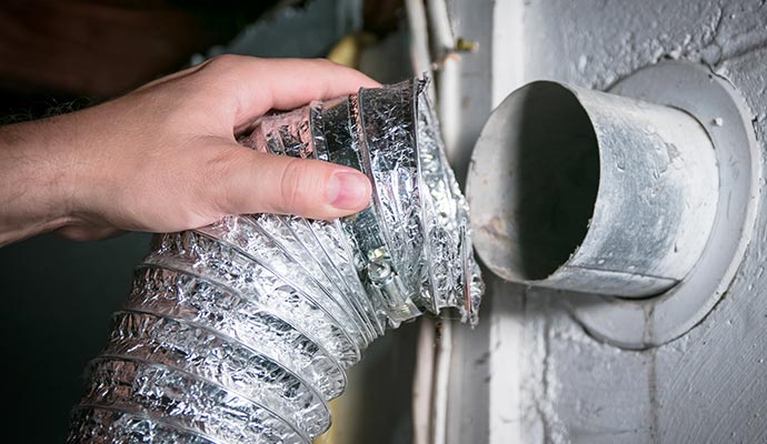 Expert re-installing air duct after cleaning