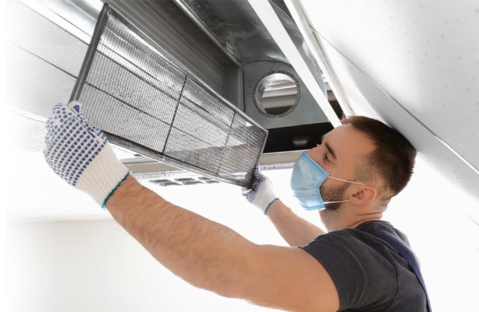 man cleaning air duct dust filter 