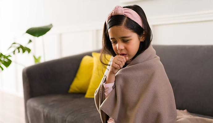 a girl coughing on the sofa
