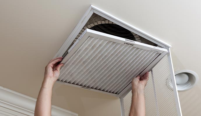 worker opening air conditioner filter